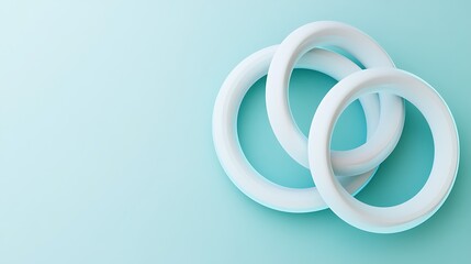 Clean and minimalistic 3D render of interlocked rings with a light blue backdrop