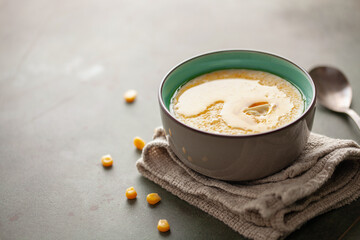 Corn porridge with butter. Healthy baby food. Copy space