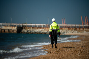 Scientist analysis professional wearing glasses and safety glove under working analysis water quality by get waste water to check water case in laboratory is environment pollution problem concept