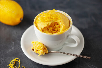 Lemon cupcake in a white mug. Easy homemade dessert. Mug cake