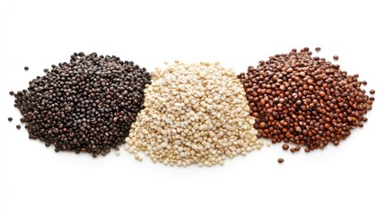 Three varieties of quinoa grains arranged in piles.