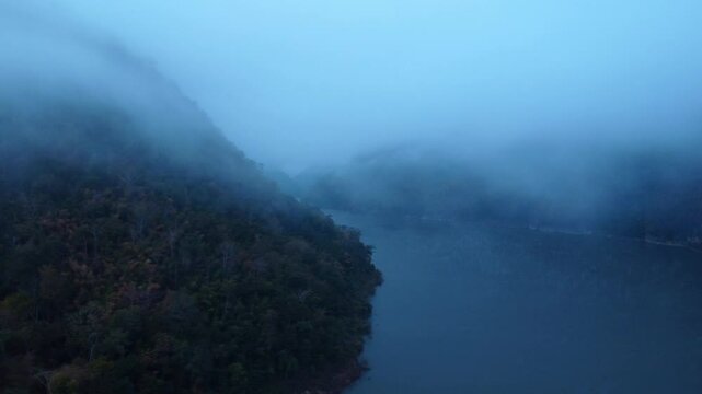 Aerial view of beautiful fog on the lake in the morning. Fresh early morning in the forest near the river. Beautiful sunrise in the forest with fog.