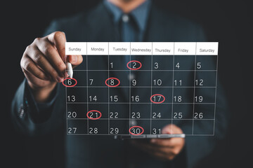 Calendar agenda appointment meeting schedule concept. Businessman using pen to writing circle red mark on virtual calendar. Planning Organizer, Time management, Manage event time for effective work.
