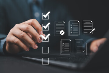 Digital form checklist, Online survey concept. Man interacts with digital form checklist on laptop with process of filling out online survey and completing digital forms with checkbox and document.