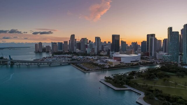Miami Florida skyline in colourful twilight light, aerial drone hyperlapse, view towards Kaseya Center and Brickell