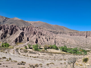 Mountain of sedimentary rocks with erosion marks in an arid canyon