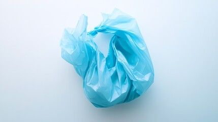 Fototapeta premium 24.A clean, isolated image of a light blue plastic bag on a stark white background, slightly crumpled with natural creases, presenting a simple, modern depiction of everyday plastic waste.