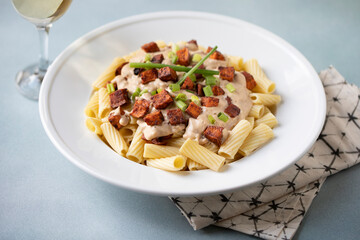 A creamy and spicy pasta dish with rigatoni, sweet potatoes, cream and scallions
