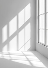 Sunlight streams through a window into a minimalist white room, casting shadows on the wall and floor.