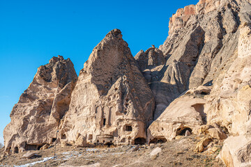 Fototapeta premium The scenic views of Selime Castle which is the largest and most elaborate cave complex in Cappadocia. The multi-level Byzantine settlement includes a kitchen, halls, church, and rooms in Güzelyurt