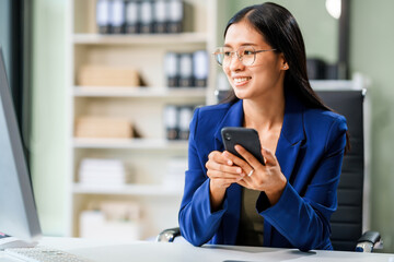 A businesswoman sits at her desk in a modern office, working on a laptop. She browses an online banking website, managing finances, analyzing transactions, and making strategic business decisions.