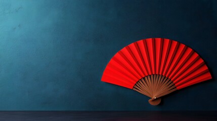 Vibrant Red Fan Against Teal Background