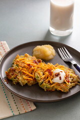 Potato, Carrot and Zucchini Latkes loaded with cheese, sour cream and bacon