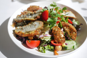 Freshly Prepared Gourmet Salad with Crispy Croquettes and Vegetables