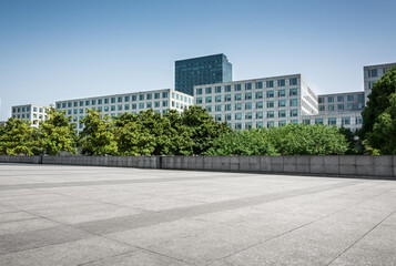 Fototapeta premium Modern Urban Architecture Surrounded by Lush Greenery on a Sunny Day