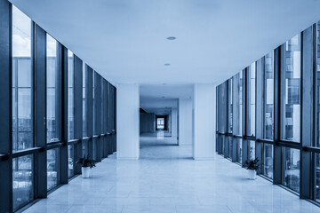 Serene Modern Office Hallway with Glass Walls and Blue Tones