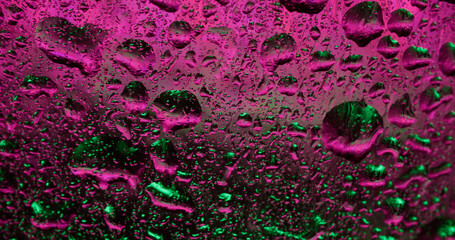 Wet texture. Neon drops. Pink green glass color glass water drip drizzle blur abstract fluorescent...