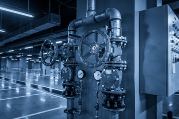 Industrial Pipe System in a Modern Facility Bathed in Blue Light