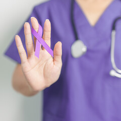 Doctor holding purple Ribbon for Violence, Pancreatic, Esophageal, Testicular cancer, Alzheimer,...