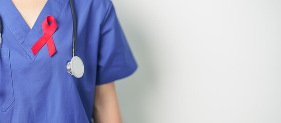 Doctor with Red Ribbon for December World Aids Day, acquired immune deficiency syndrome, multiple...