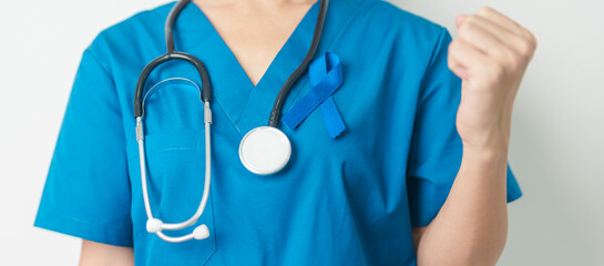 March Colorectal Cancer Awareness month, doctor with dark Blue Ribbon for supporting people living...