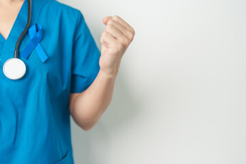 March Colorectal Cancer Awareness month, doctor with dark Blue Ribbon for supporting people living...