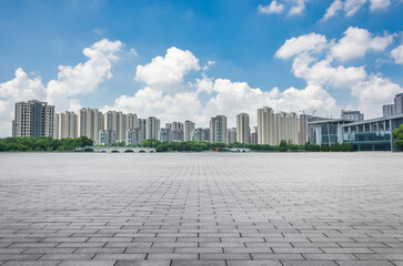 Expansive Urban Skyline under Blue Sky with Soft Clouds