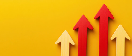 Rising arrows in red and yellow on bright yellow background symbolize economic growth and progress