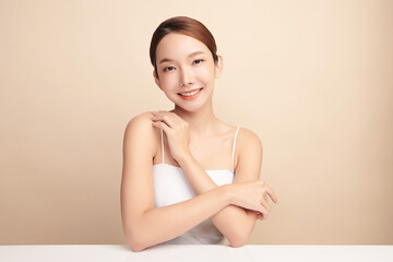 Fototapeta premium Beautiful young asian woman with clean fresh skin on beige background, Face care, Facial treatment, Cosmetology, beauty and spa, Asian women portrait.