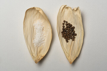 Especias para tamales, sal, pimienta, laurel sobre una hoja seca de maíz, cocina tradicional...