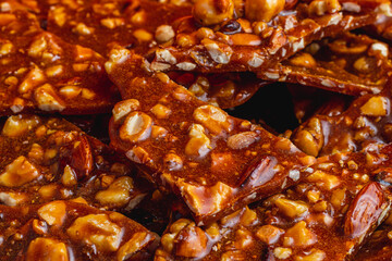 Homemade sugar cookies with nuts on a shiny red plate close up