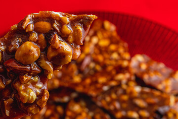 Homemade sugar cookies with nuts on a shiny red plate