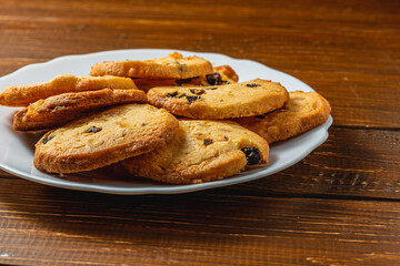 Delicious homemade Christmas cookies with raisins on a white plate