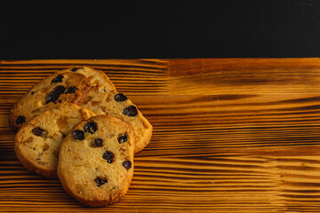Festive homemade cookies with raisins on a wooden table