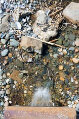 Water Flowing Over Vibrant Gravel in Clear Stream
