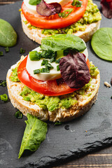 Healthy eating concept, rice cakes with avocado, mozzarella, spinach and onion