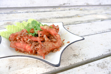 Side view. Fried shrimp with garlic and pepper on wooden table is a popular Thai.