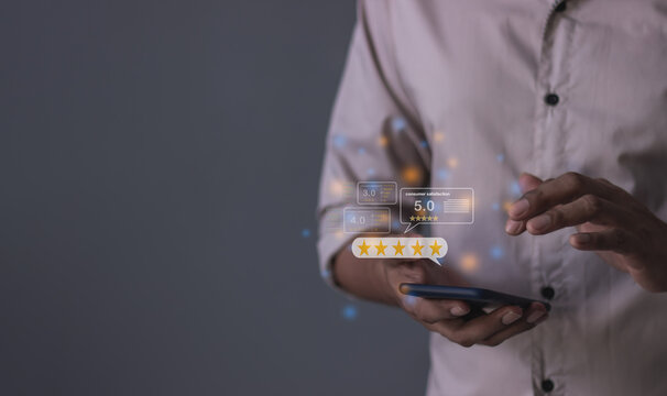 Consumer Satisfaction, Young Man hand using smartphone mobile with five star to review and give 5 stars with very good results in service, Good review 5 star rating choice feedback