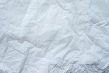 Full frame shot of crumpled tissue fabric texture and background. Tissue fabric is slightly rough and crisp in texture.