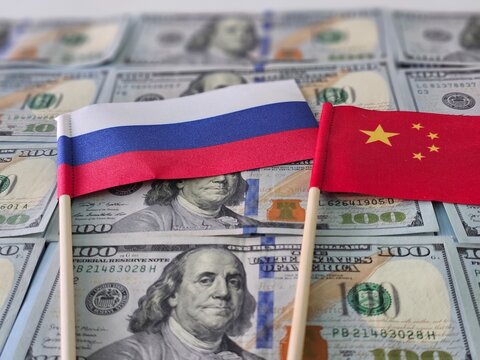 Russian and Chinese flags placed on US currency, symbolizing international relations and trade dynamics in 2023 - Powered by Adobe