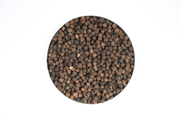 Black pepper in white background, top view.
