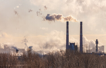 A smoggy sky with a large industrial plant in the background