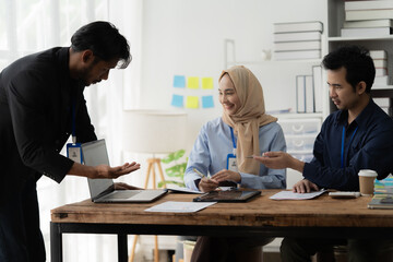 Collaborative Teamwork: A diverse team of professionals engages in a productive discussion, showcasing collaboration, communication, and a shared workspace.