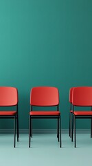 Obraz premium Four red chairs are lined up against a teal wall, creating a modern and minimalist aesthetic.