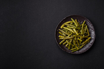 Steamed green beans on a plate with olive oil, sesame seeds