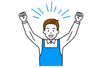 ガッツポーズで大喜びするエプロン姿の男性