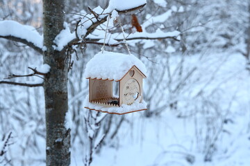 Enjoy the Winter Wonderland with a snowcovered birdhouse in a serene, tranquil landscape