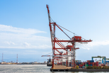 Container port and container crane at Industrial port for cargo container ship Osaka Japan....