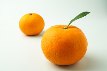 Ripe tangerines and Green orange leaves isolated on white background. Concept for Chinese Lunar New Year.