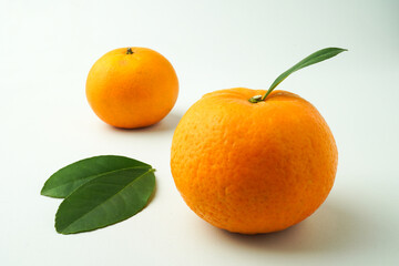 Ripe tangerines and Green orange leaves isolated on white background. Concept for Chinese Lunar New Year.